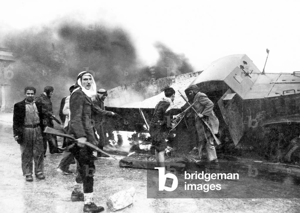 israel palestine: palestinian fighters beside a burned out israeli haganah supply truck near jerusalem, arab israeli war, 1948